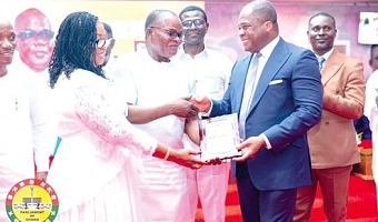 Rev. Stephen Yenusom Wengam (2nd from right), General Superintendent of the Assemblies of God, Ghana, presenting Ebenezer Ahumah Dzietror an award of significant achievement from the church
