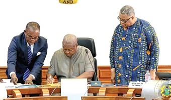 President Mahama (middle) assenting to the 24-Hour Economy Bill. With him are Goosie Tanoh (right), Presidential Advisor, 24-Hour Economy, and Ebenezer Djietror, Clerk to Parliament