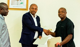Professor Mawutor (right), Vice-Chancellor, UPSA,  exchanging the signed documents with Philip Gamey, Executive Chairman of Hallmark Research Lab. Looking on is Emmanuel Kwadwo Agyekum, Minister of State in Charge of Special Initiatives 