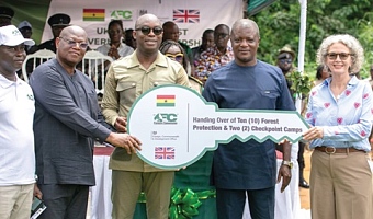 Dr Terri Sarch (right), acting Deputy British High Commissioner, and Dr Hugh C.A Brown (middle), Chief Executive of the Forestry Commission, displaying a dummy key to the forest protection camps. With them is Isaac Essien (right), Chairman, Forestry Commission Board, and other officials