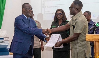 Paul Baffoe-Bonnie (left), acting Chief Justice, presenting the FLEGT Licence Certificate to Richard Nsenkyire (right), General Manager of Samartex Timber and Plywood Co. Ltd