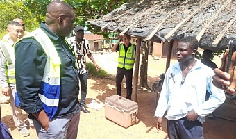 Governs Agbodza (left), Minister of Roads and Highways, interacting with some community members at Nsuano, along the Elubo-Enchi road 