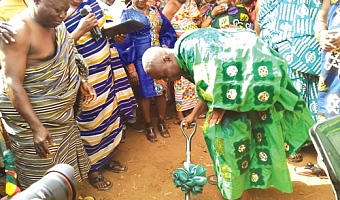 Osagyefo Oseadeeyo Agyemang Badu (with the pickaxe), President of the Bono Regional House of Chiefs, cutting the sod for the start of the project