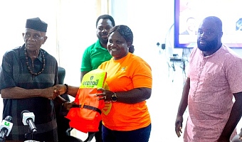 Yaa Oforiwaa (2nd from right), National Coordinator, Volta Lake Transport Safety Project, presenting the vests to John Kwadwo Gyapong, Oti Regional Minister