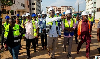 Mr Courage Nunekpeku ( with hand stretch) Managing Director of TDC Ghana Ltd conducting Mr Kenneth Gilbert Adjei, (2nd left) Minister of Works Housing and Water Resources round the buildings at the Kpone Affordable Housing Project site.