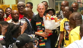 Hundreds of football-loving fans lined up at the airport to welcome Carlos Queiros amid drumming and dancing.