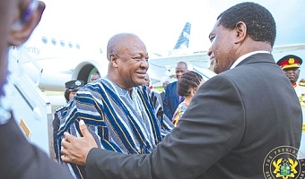Hakainde Hichilema (right), President of Zambia, in a hearty chat with President John Dramani Mahama