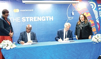 Kwamina Asomaning, Chief Executive of Stanbic Bank Ghana, and Kyle Kelhofer, IFC Senior Country Manager for Ghana and Nigeria, signing the agreement.