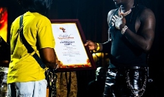 Stonebwoy (right) receiving the Certificate of Appreciation from Grace Hunu