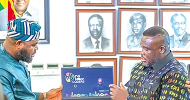 Samuel Nartey George (right),  Minister of Communication, Digital Technology and Innovations; and Mohammed Adams Sukparu, Deputy Minister of Communication, Digital Technology and Innovations, displaying one of the laptops