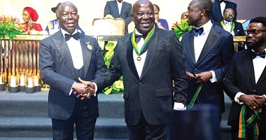 Otumfuo (left) congratulates Sir Sam Jonah