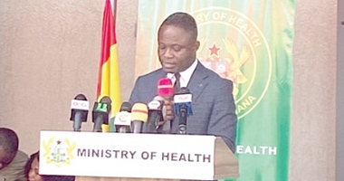 Kwabena Mintah Akandoh (left), Minister of Health, administering the oath to members of the board