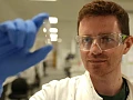 Researcher Alex Sampson holds the experimental Ebola vaccine