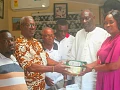Yvonne Aryee, Snr. Corporate Communications Officer at Graphic Communications Group Ltd, presenting items to Daniel Nii Addy (2nd from left), an elder of the Adabraka Stool. Accompanying them are Tetteh Adjabeng II (2nd from right), the Adabraka Manste, along with some elders of the Adabraka Stool. Picture: ESTHER ADJORKOR ADJEI 