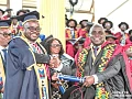 Dr Julius Debrah (right), the Chief of Staff, receiving his PhD during the graduation ceremony at the University of Ghana, Legon