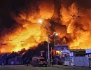 Firefighters work at the site of a book market hit by a Russian missile strike in Kyiv