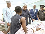 President John Dramani Mahama (3rd from right) in a chat with an injured officer admitted to the new block during the ceremony