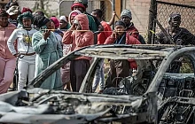 Gunmen torched vehicles as they fled the scene of a mass shooting at bar near Johannesburg