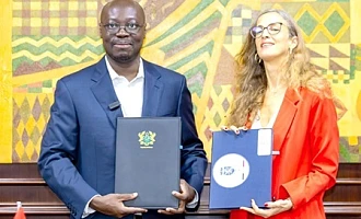 Dr Cassiel Ato Forson (left), Minister of Finance, and Carole van Eyll, Ambassador of Belgium, displaying the agreement