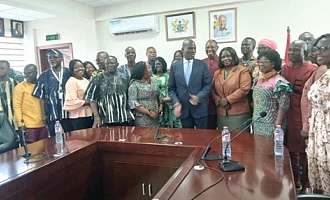 Haruna Iddrisu (arrowed), Minister of Education, assisted by Dr Clement Apaak (behind), Deputy Minister of Education, with some heads of Special Schools and some members of the disability community