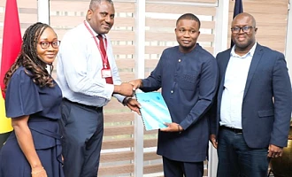 Franklin Sowa (2nd from left), Director, Marketing and Sales, GCGL; presenting the report to Benjamin Avornyotse, acting Director for Communications, International Cooperation and Strategic Partnerships, Cyber Security Authority. Looking on are Linda Aryee (left), Manager, Marketing, Corporate and Investment Banking, Stanbic Bank, and Theophilus Botchway (right), Principal Manager of Law Enforcement Liason Unit, Cyber Security Authority. Picture: ELVIS NII NOI DOWUONA 