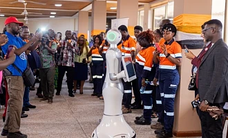 A robot developed at the AngloGold Ashanti Iduapriem Smart Systems Centre is displayed by students of the University of Mines and Technology (UMaT) during the commissioning of the facility in Tarkwa