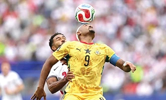 Ghana’s Jordan Ayew wins an aerial battle against Reece James of England during yesterday’s game