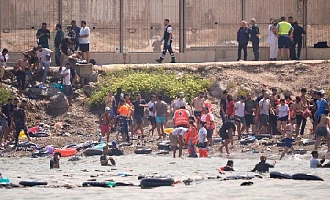 Nine dead as thousands of migrants enter Spanish enclave from Morocco