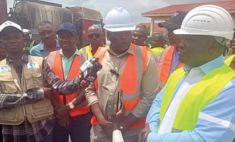 Kwame Governs Agbodza (middle), Minister of Roads and Highways, speaking to the media after inspecting the ongoing road construction leading to the Sewua Hospital. Looking on is Dr Frank Amoakohene (right), Ashanti Regional Minister