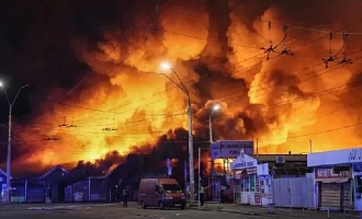 Firefighters work at the site of a book market hit by a Russian missile strike in Kyiv