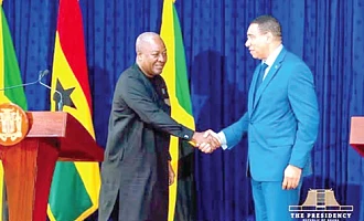 President Mahama (left) exchanging pleasantries with Andrew Michael Holness, Jamaican Prime Minister, after the media briefing