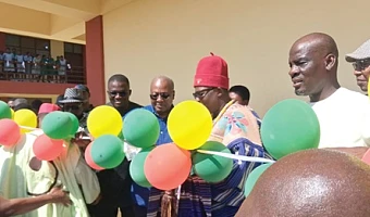 President John Mahama being supported by Pe Gideon Awolugu (2nd from right), Chief of Nakolo, and Nikyema Billa Alamzy (2nd from left), MP, Chiana-Paga Constituency, to cut the ribbon while Haruna Iddrisu (right), Minister of Education, looks on