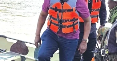 Emmanuel Armah Kofi Buah (front) with some military personnel on a tour of River Ankobra River to combat illegal mining