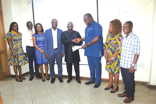 • Dr Kodjo Esseim Mensah-Abrampa (middle), Director-General, National Development Planning Commission, presenting the Agenda for Jobs II to Theophilus Yartey (3rd from right), Editor, Graphic, during the visit. Picture: ESTHER ADJORKOR ADJEI